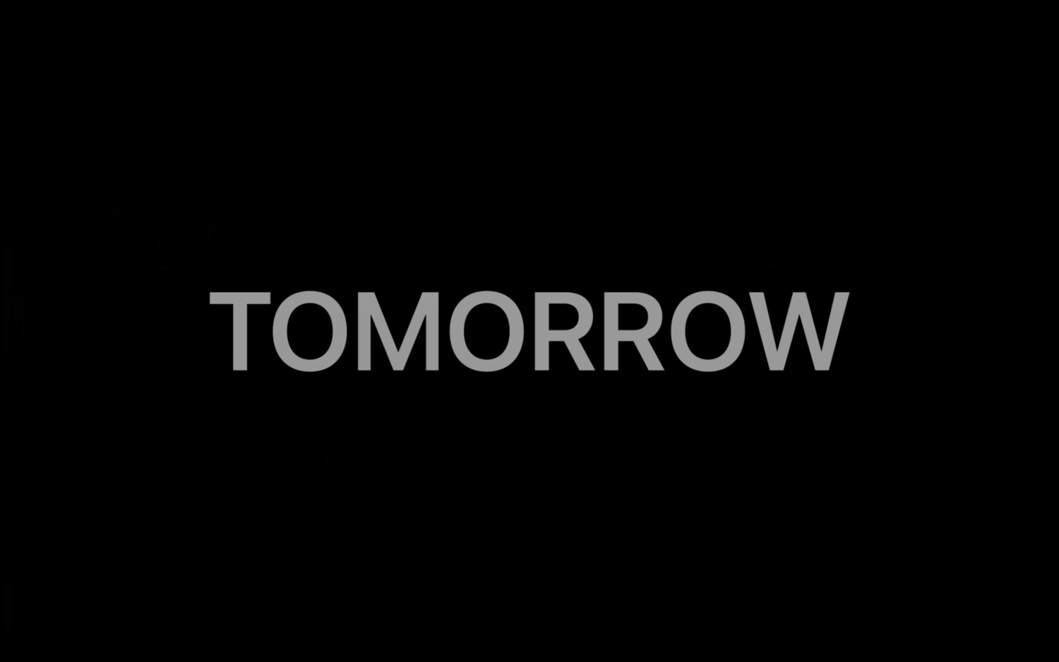Preview-Motiv für Tomorrow-VIdeo. Das Wort "TOMORROW" steht auf schwarzem Hintergrund